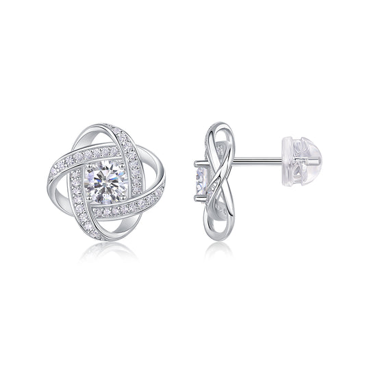Silver earrings with intricate designs on a white background