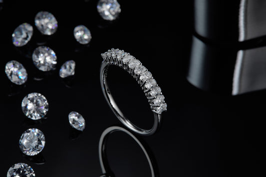 Diamond ring with scattered diamonds on a dark background
