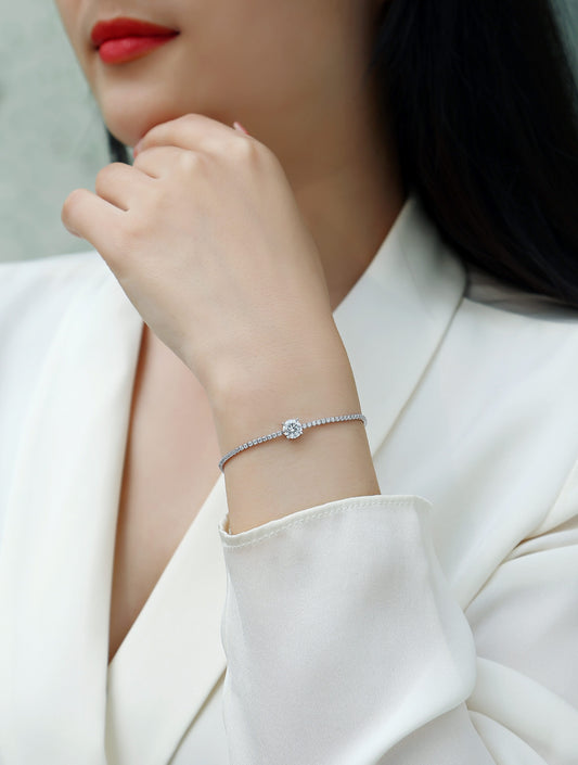 Close-up of a person wearing a bracelet on a light background